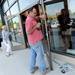 Mark Wagner, of United Glass in Chesterfield Township, installs a handle on the door of Hot Mama during the grand opening of Arbor Hills on Thursday, August 22, 2013. Melanie Maxwell | AnnArbor.com